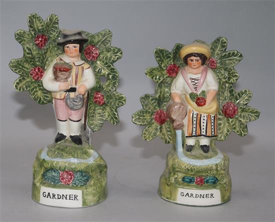 A pair of Staffordshire pottery figures of gardners 14cm, 14.5cm